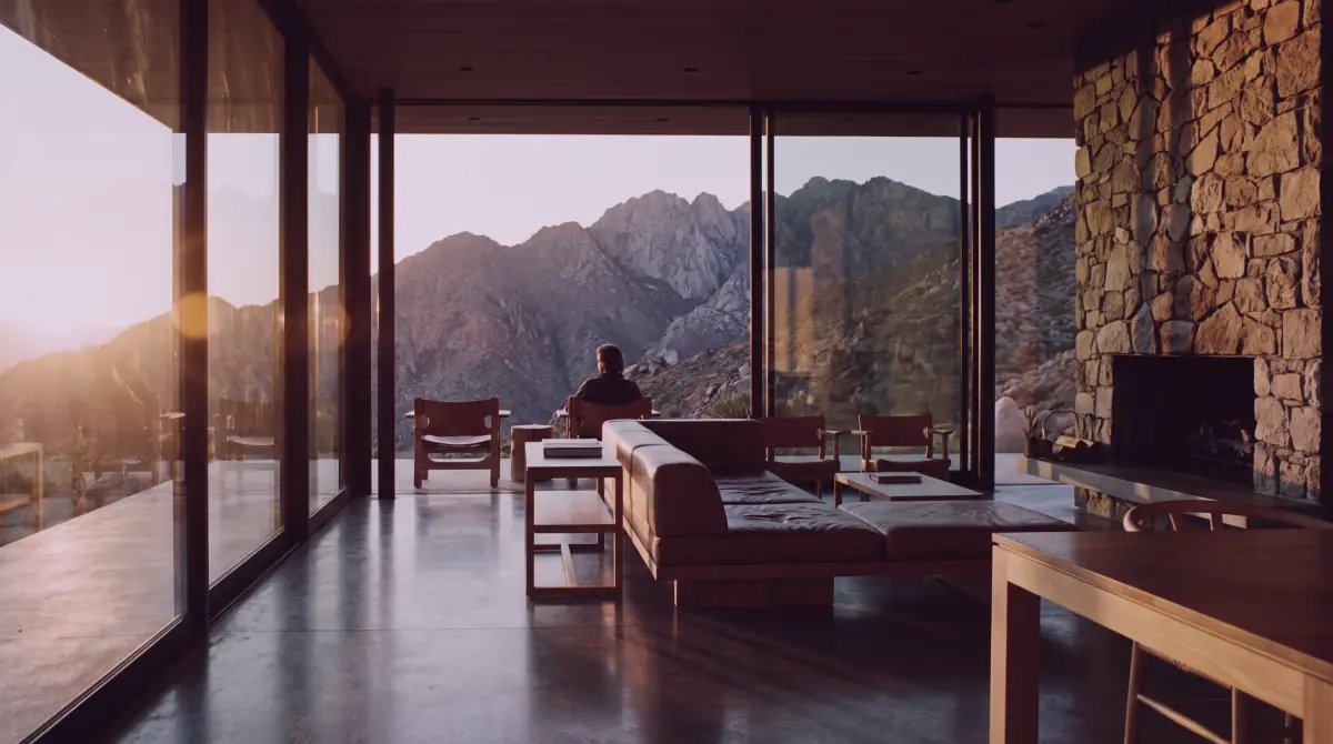 Modern interior with floor-to-ceiling windows at sunset