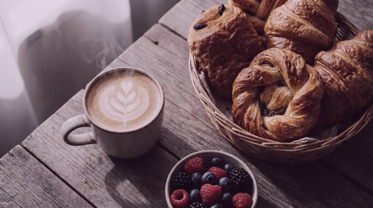 Overhead flat-lay of artisan pastries beside a latte