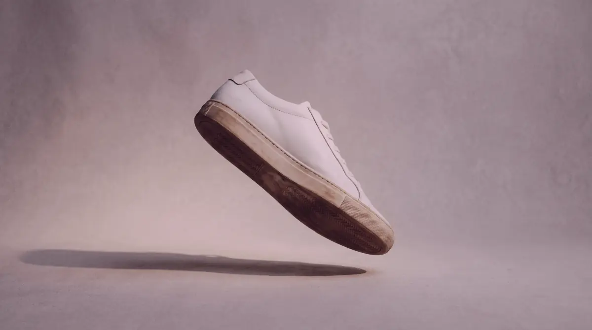 Minimalist sneaker product shot under dramatic side lighting