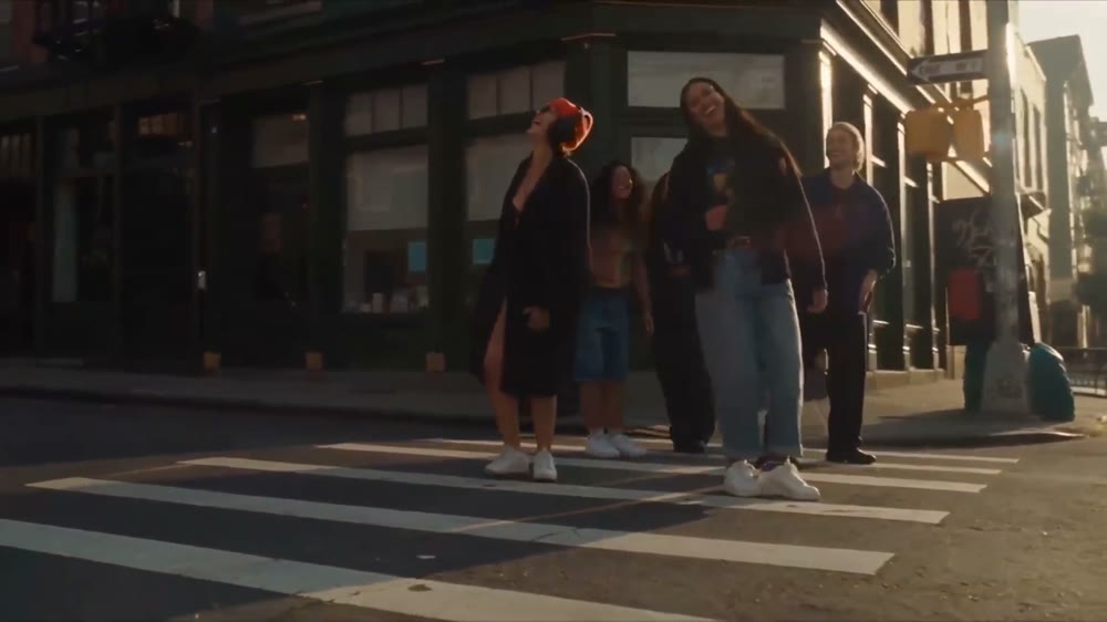 Last frame of the street film: four people standing together on the same crossing at the end of the film.