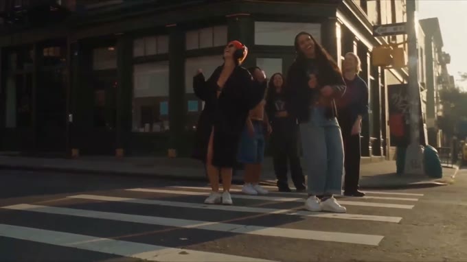 Final wide: she stands on the crossing at the end of the film with three other people.